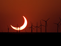 Partial solar eclipse with windmills